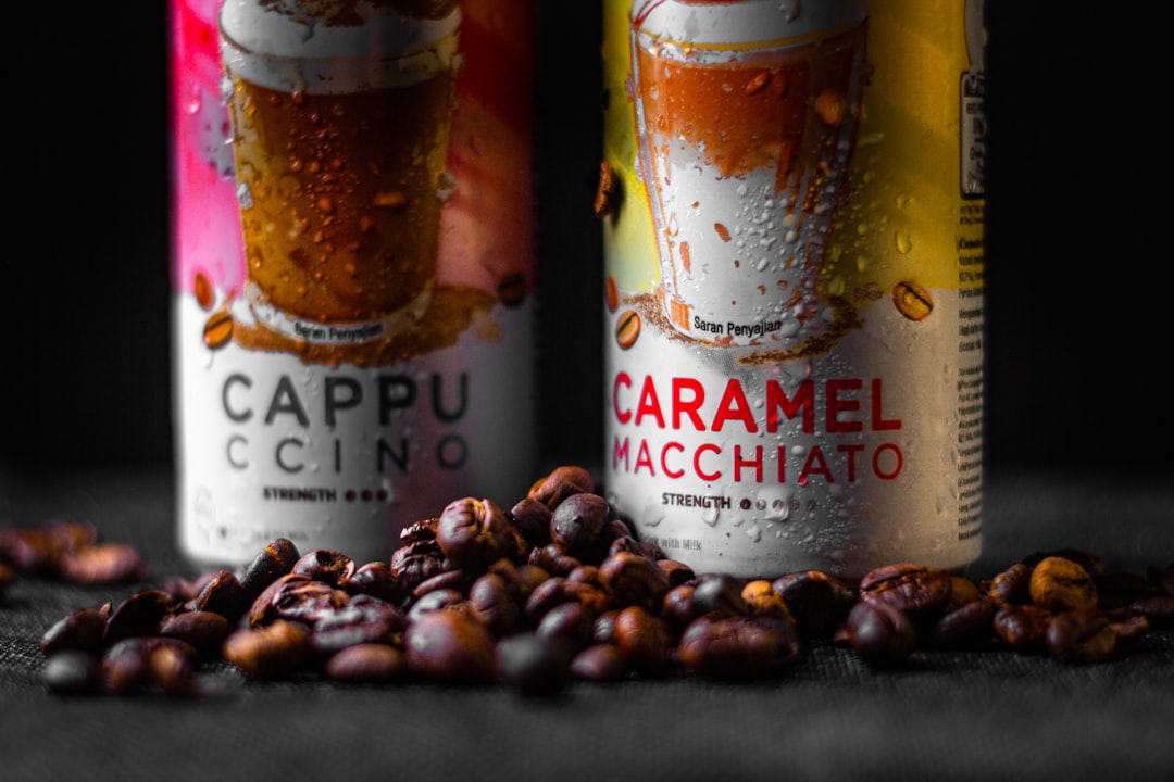 two-cans-of-caramel-macchiato-on-a-table-rzweualf0xw